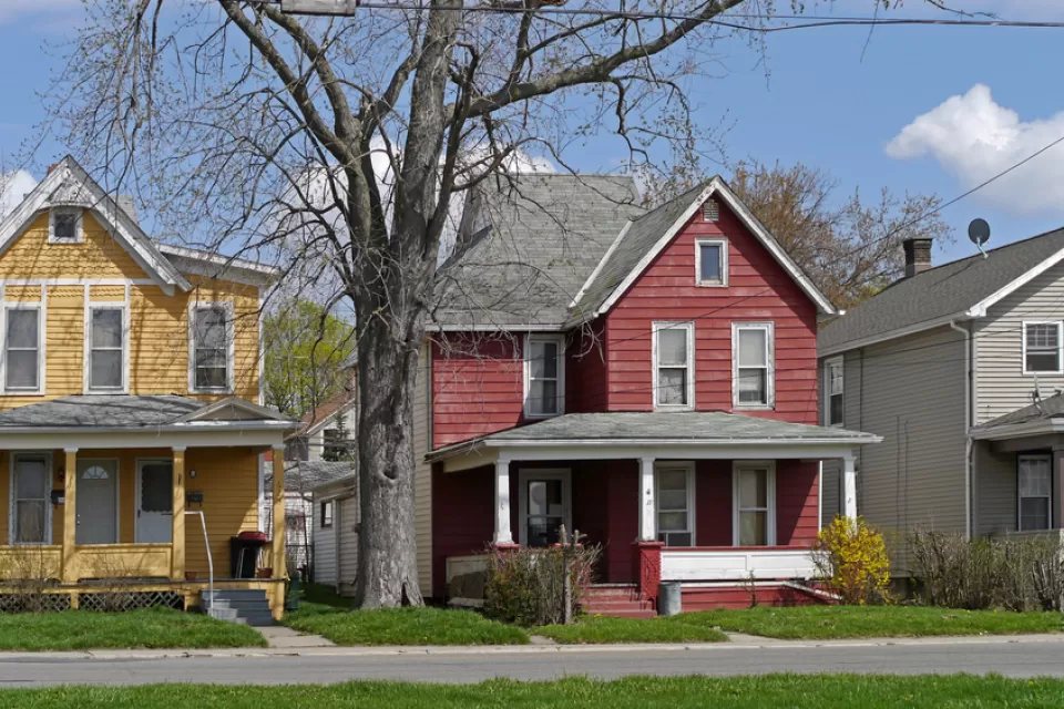 Old houses with large porch and colorful siding
